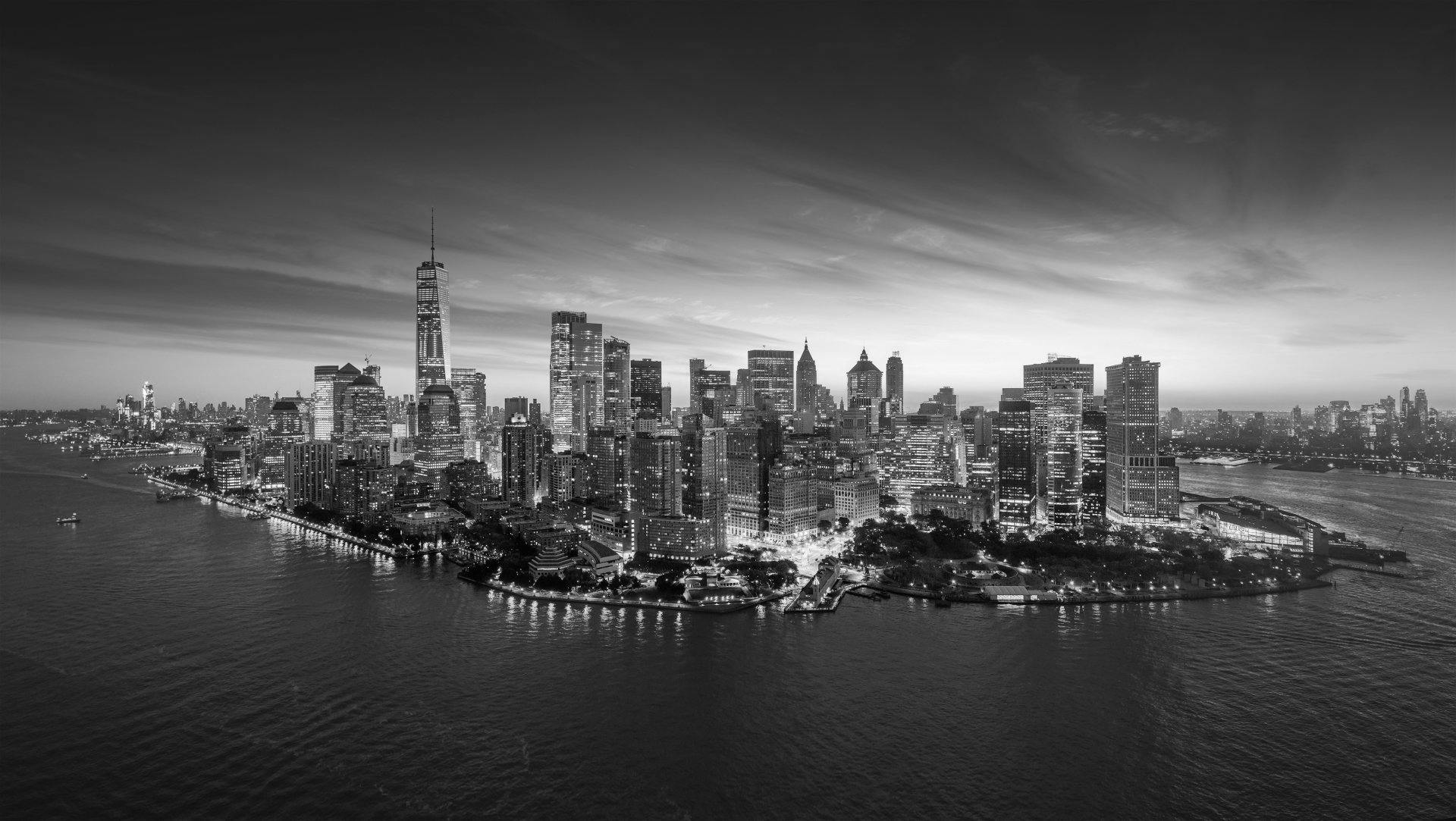 A black and white photo of the new york city skyline at night.