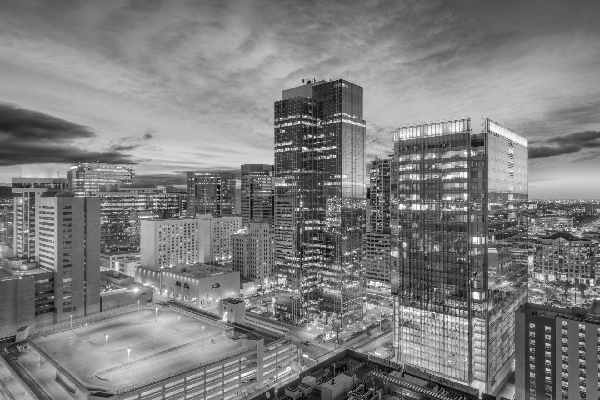 A black and white photo of a city skyline at night.