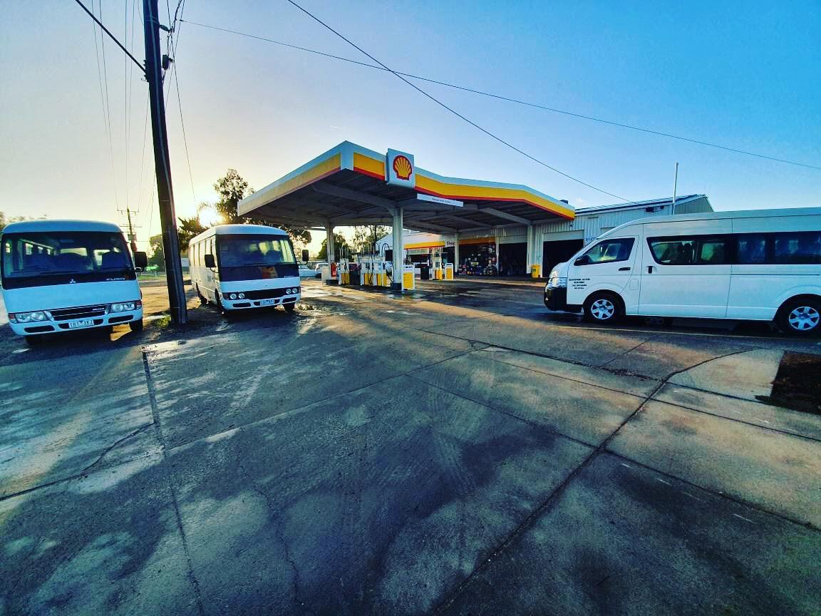 A gas station and a lot of cars are parking | Mildura, VIC | Benetook Automotive & Bus Hire