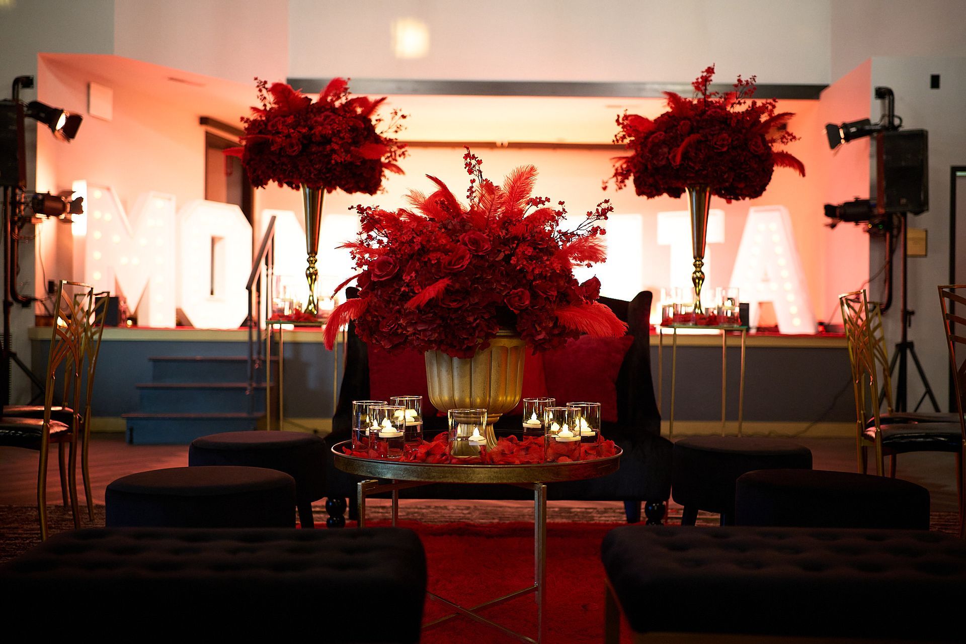 A room with red flowers and a large m on the wall