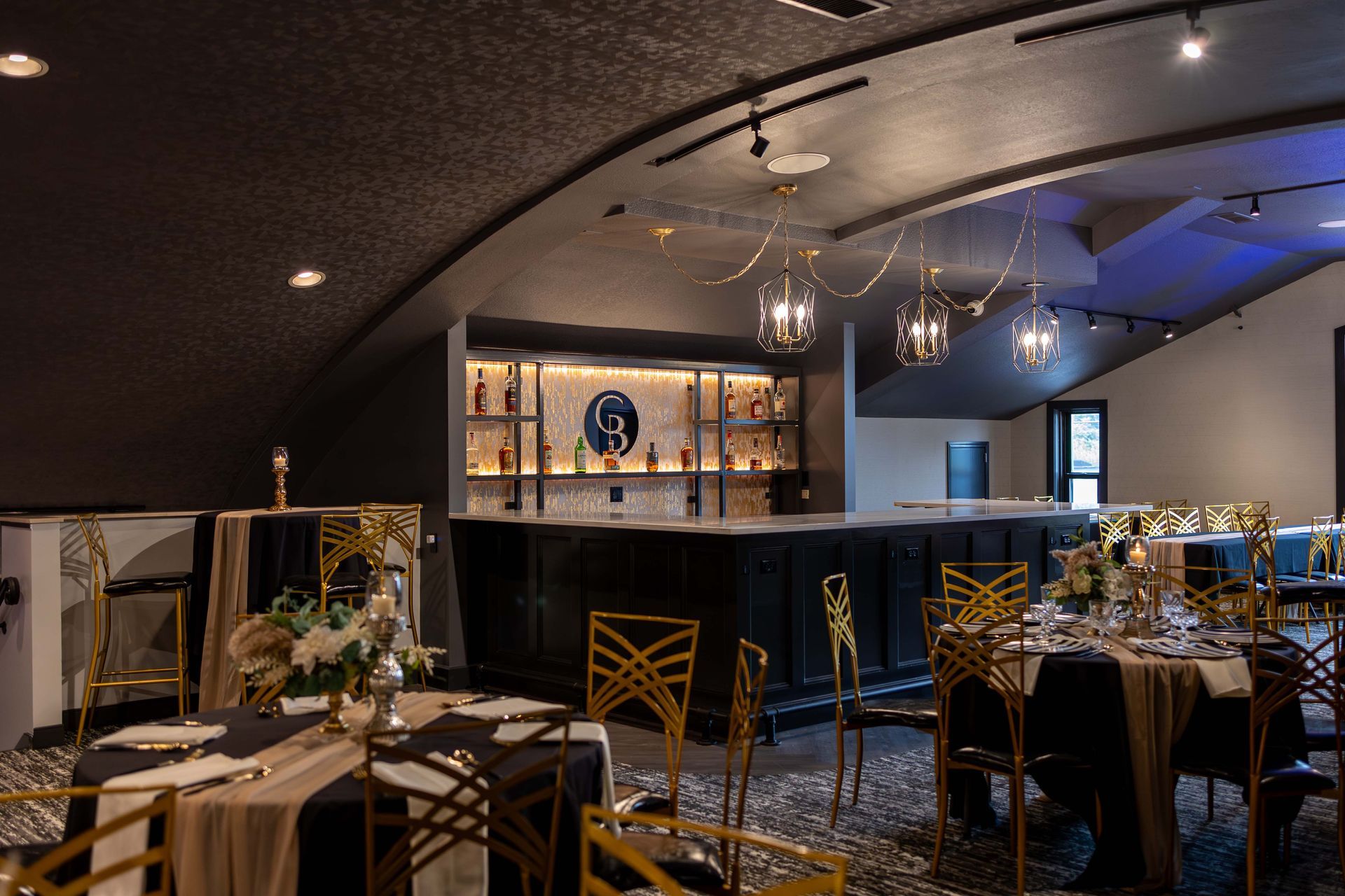 A large dining room with tables and chairs and a bar.