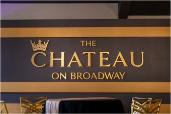 A sign for the chateau on broadway is on a wall