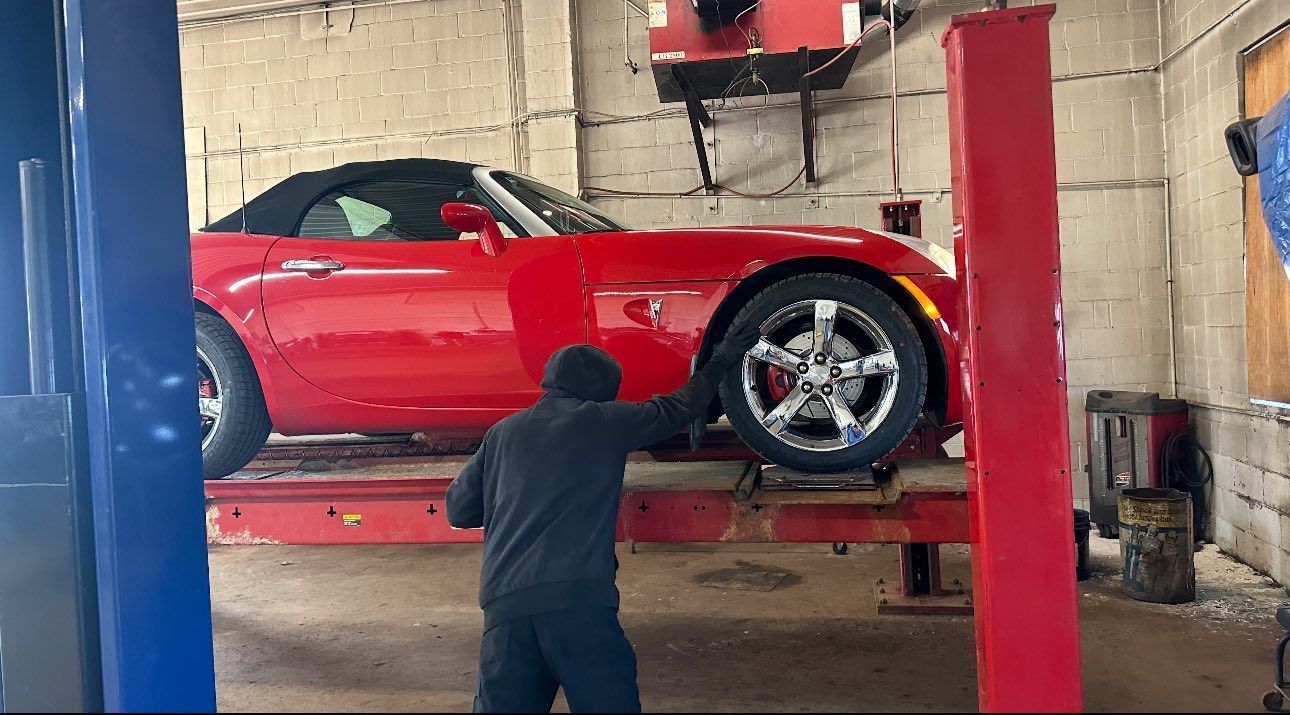 Pontiac Solstice Sports Car Being Serviced on a Lift | Tire City Auto Repair