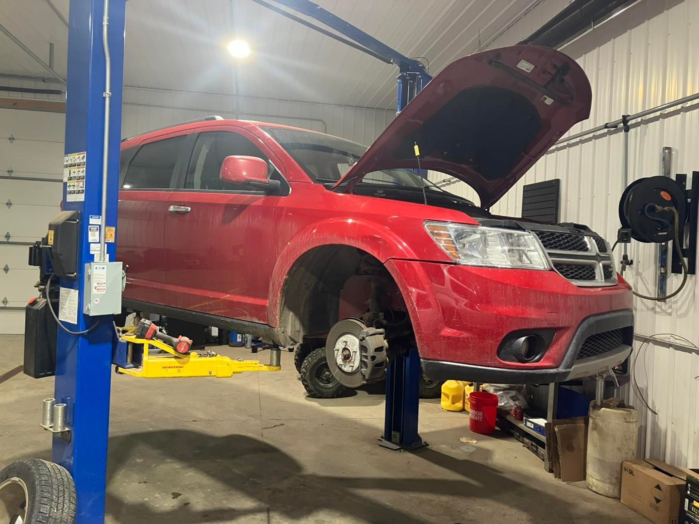 Red Dodge Journey SUV Undergoing Maintenance | Tire City Auto Repair