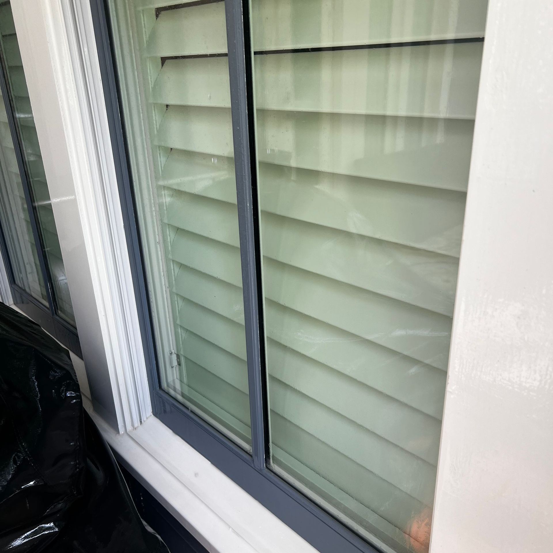 A close up of a clean window with blinds on it