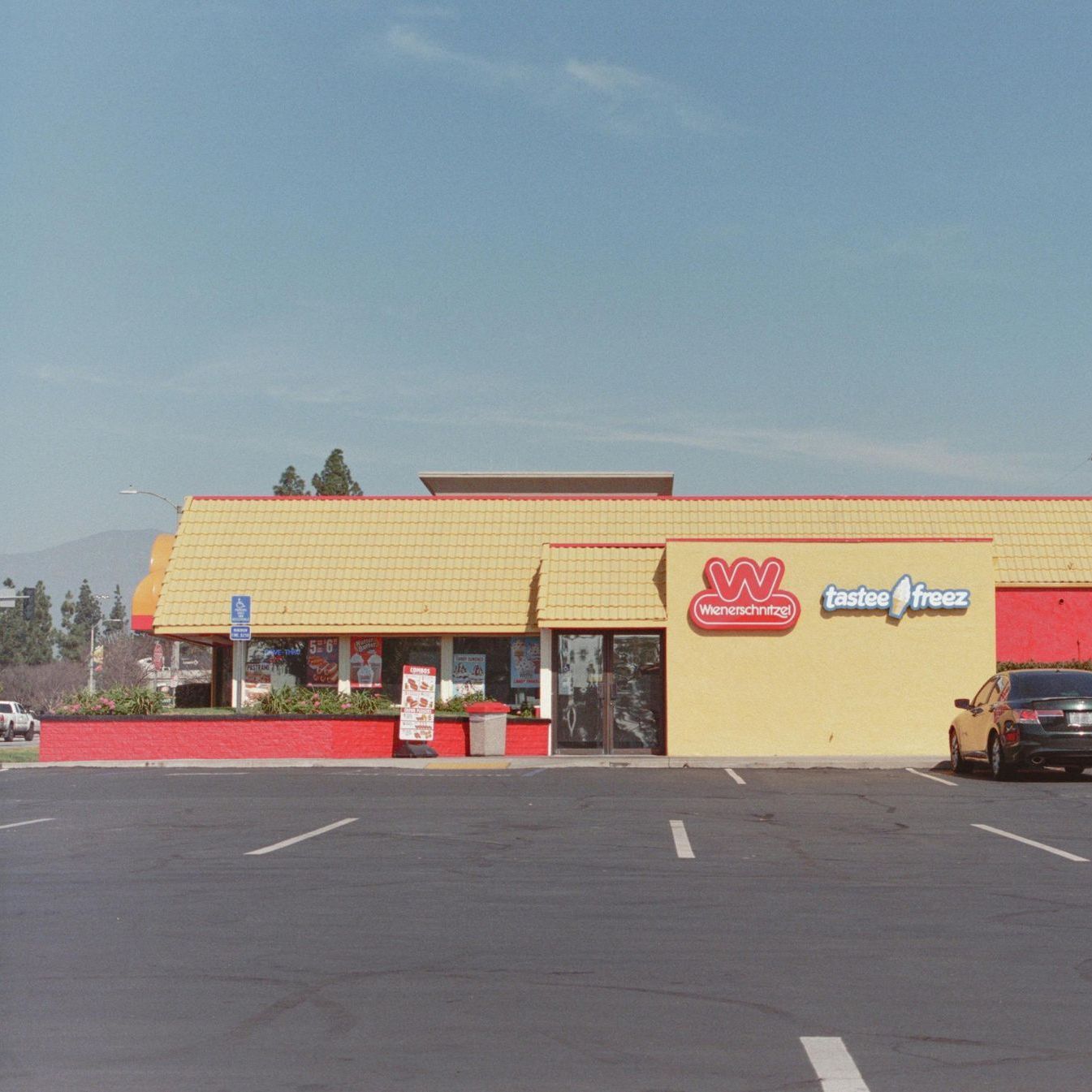 A yellow building with a red sign that says faster fresh