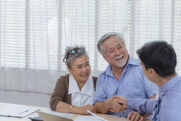 Estate planning discussion between an elderly couple and a man guiding their future plans.