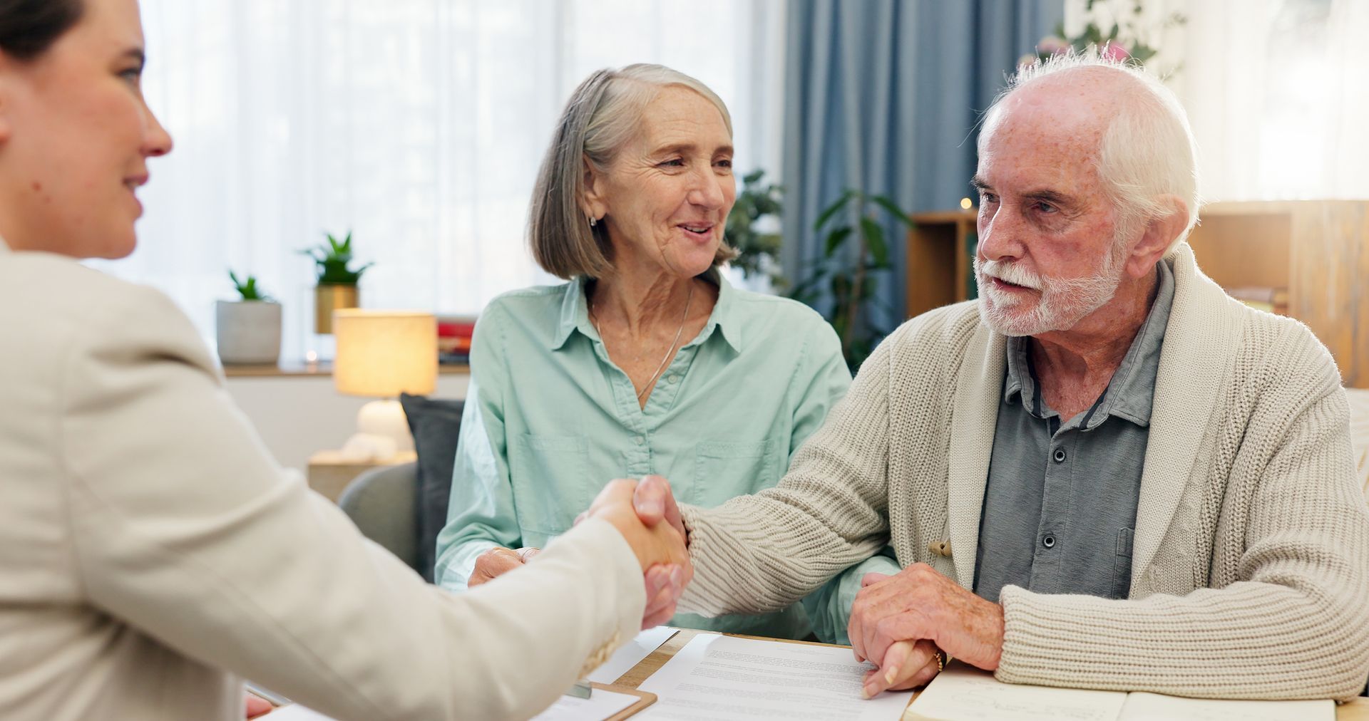 Old couple with estate planning paperwork for a will for final wishes.