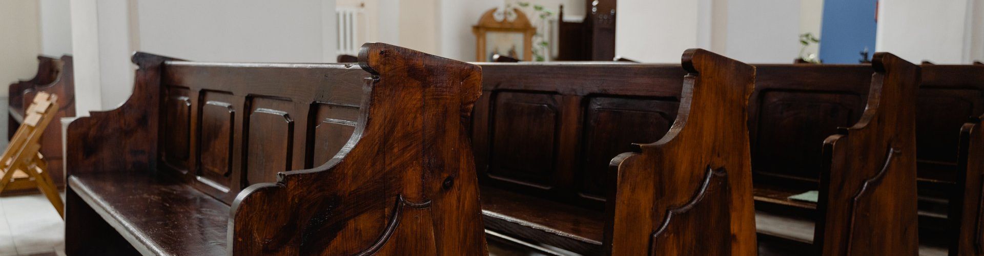 a row of wooden benches in a church