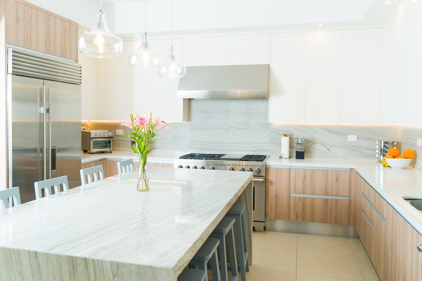 A person in a white apron is working in a kitchen