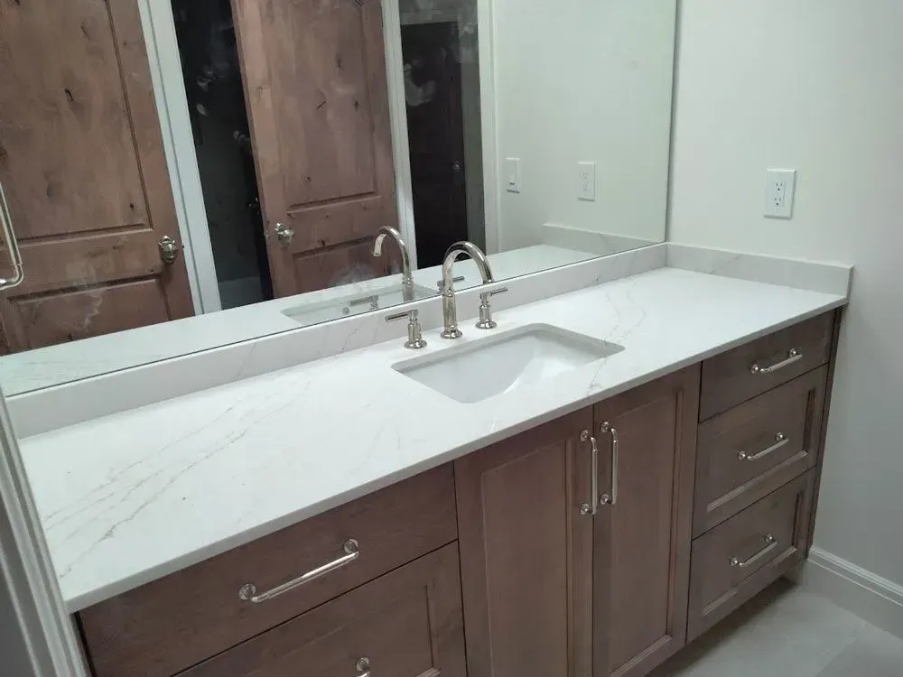 A bathroom with a double sink and a large mirror.