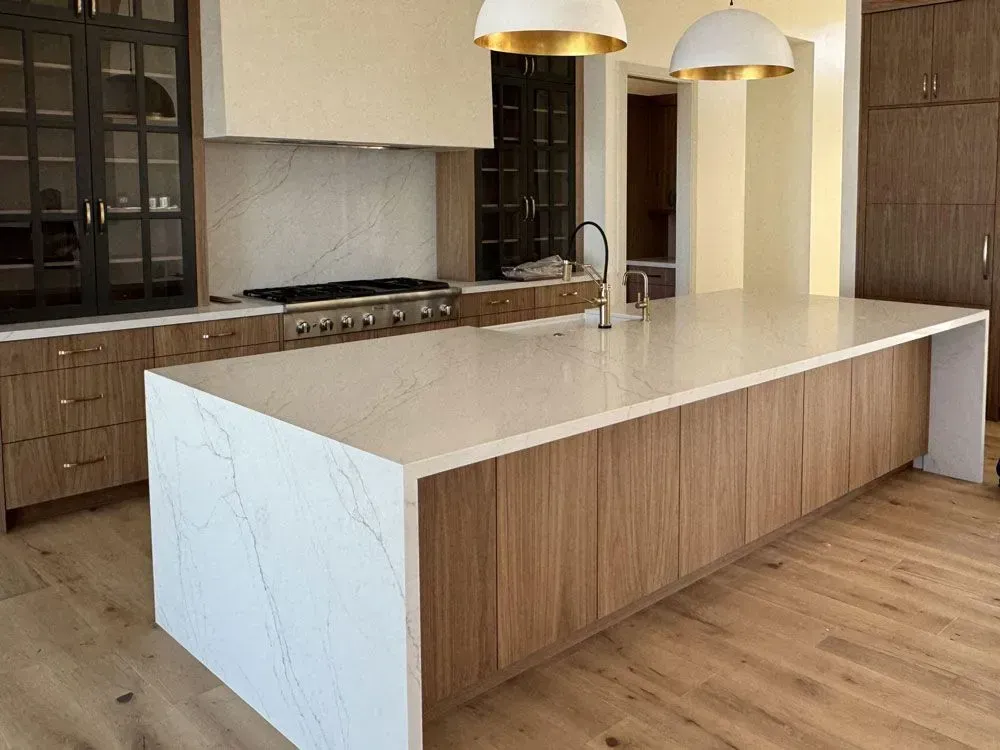 There is a large island in the middle of the kitchen.