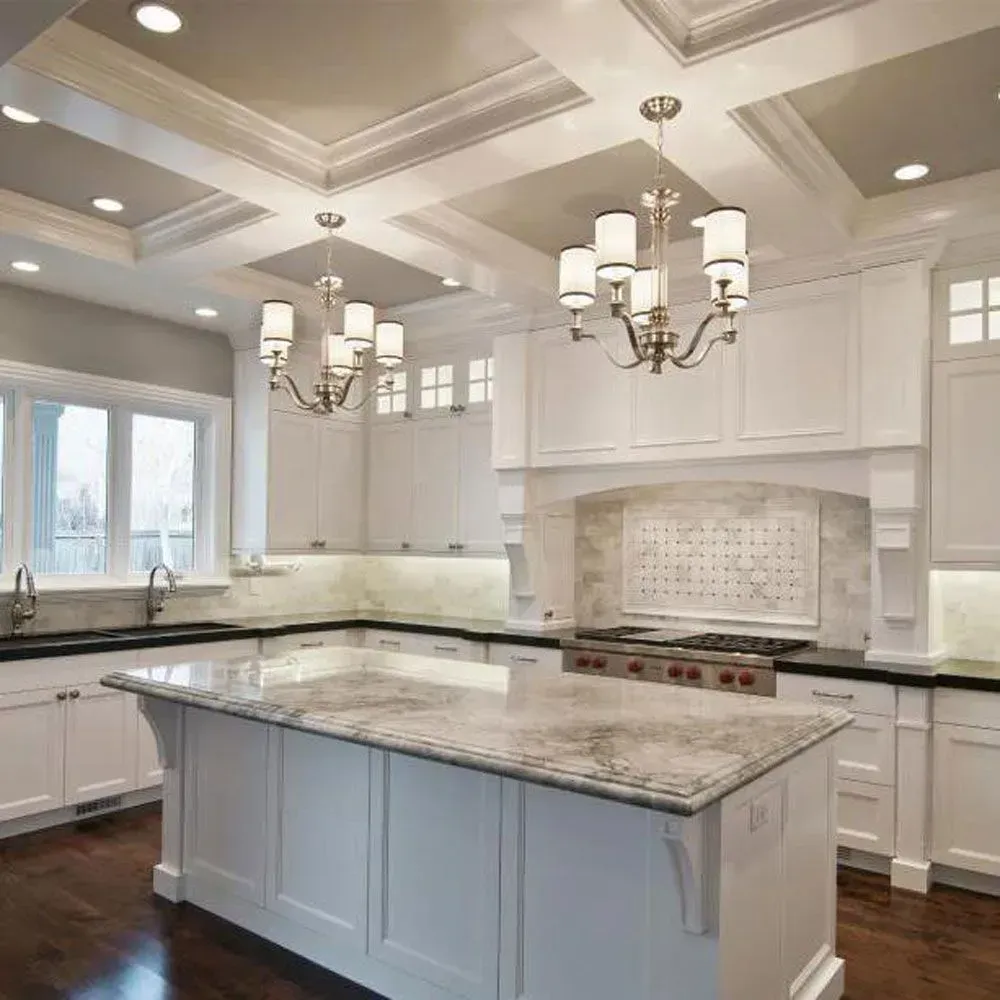 A kitchen with white cabinets and a large island