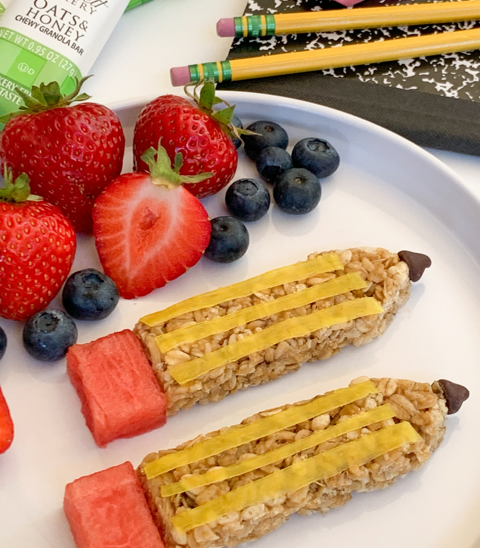 oats and honey granola bars decorated like pencils with fresh blueberries and strawberries