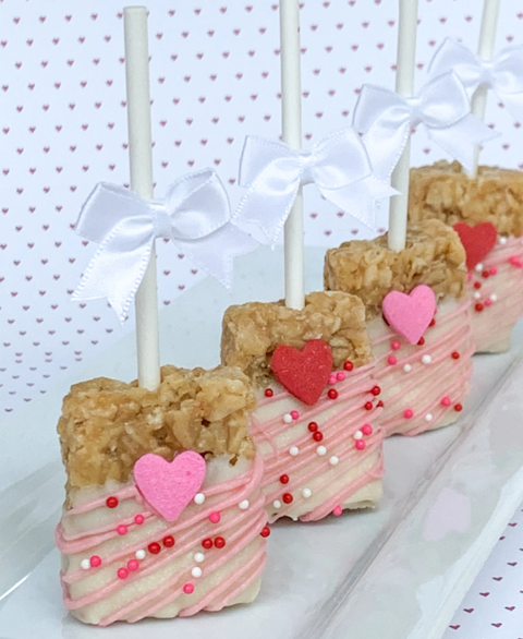 granola bar halves topped with festive icing and sprinkles for valentines