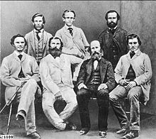 A group of men are posing for a picture together in a black and white photo.