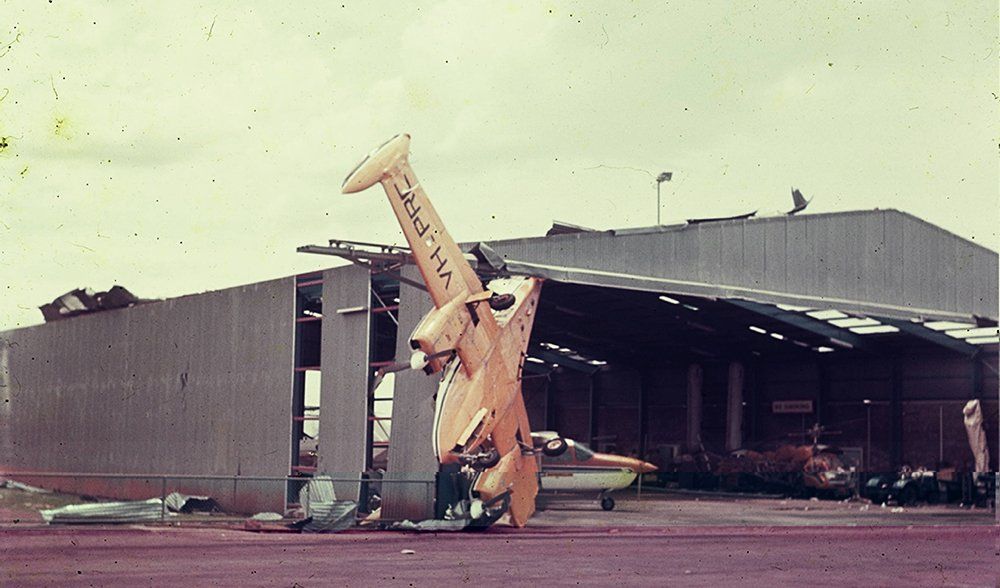 A yellow airplane with the letters aa on the tail