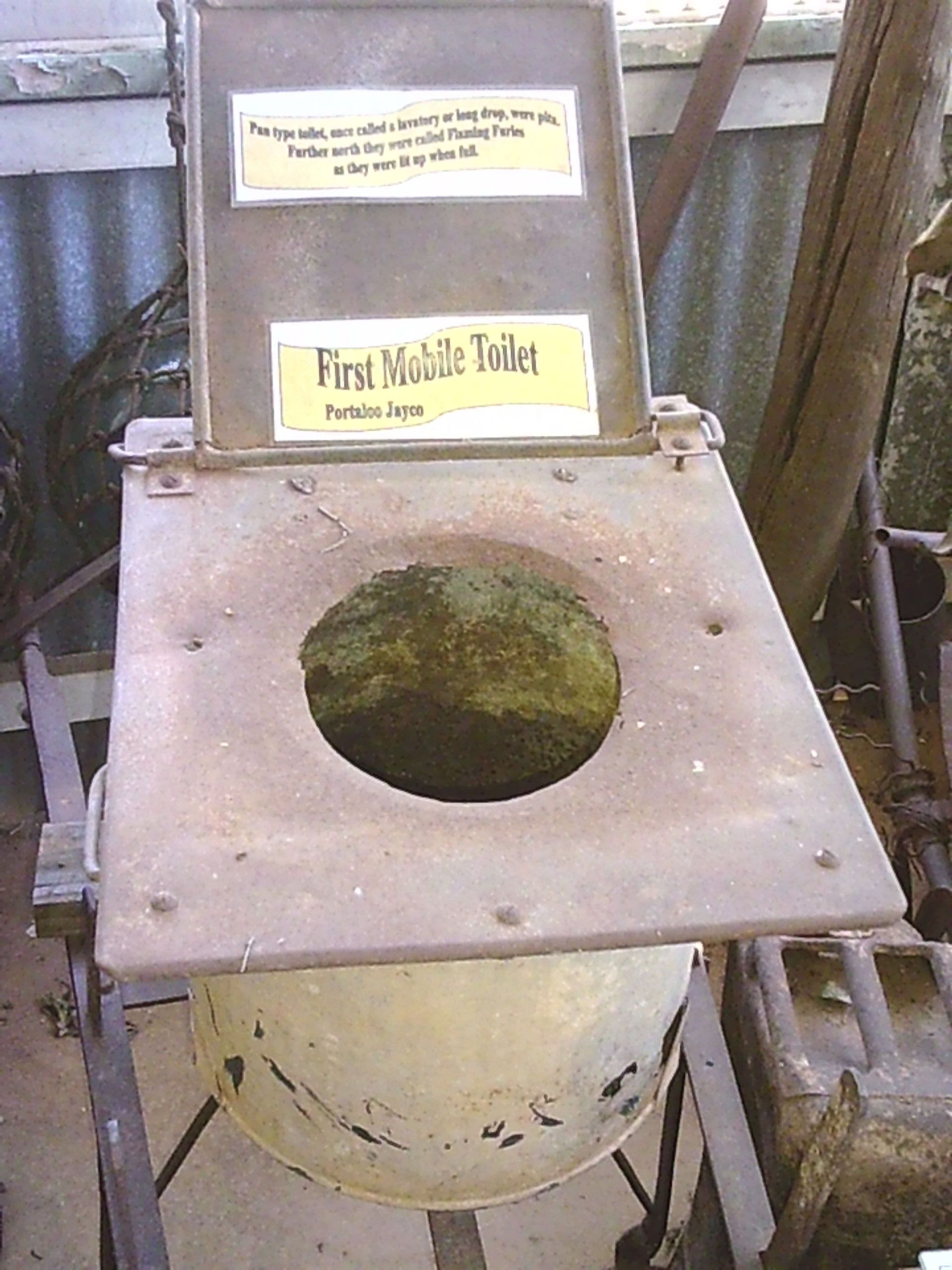 A toilet with a sign that says first mobile toilet