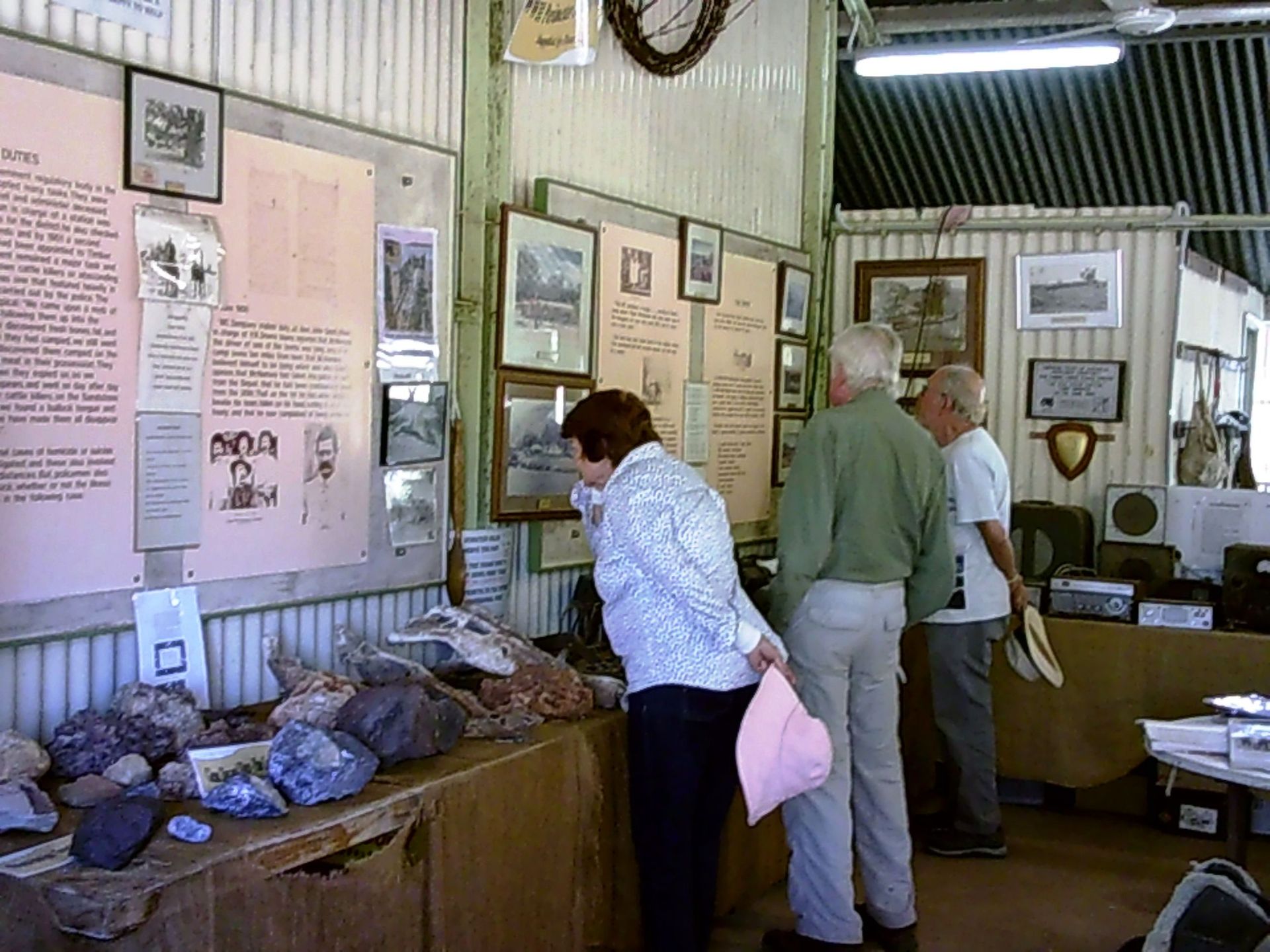 A group of people are looking at rocks in a museum