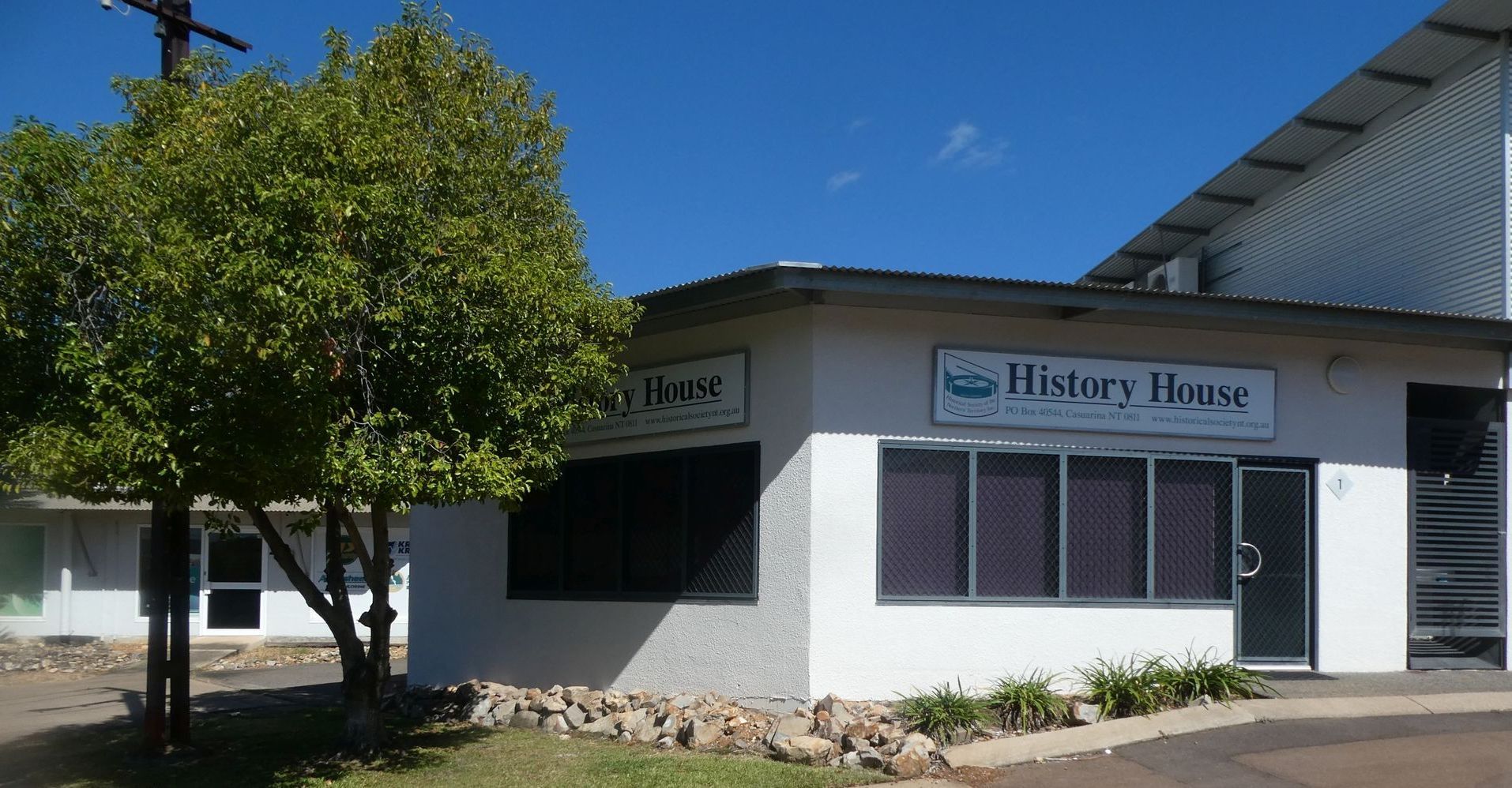A white building with a sign that says History House 