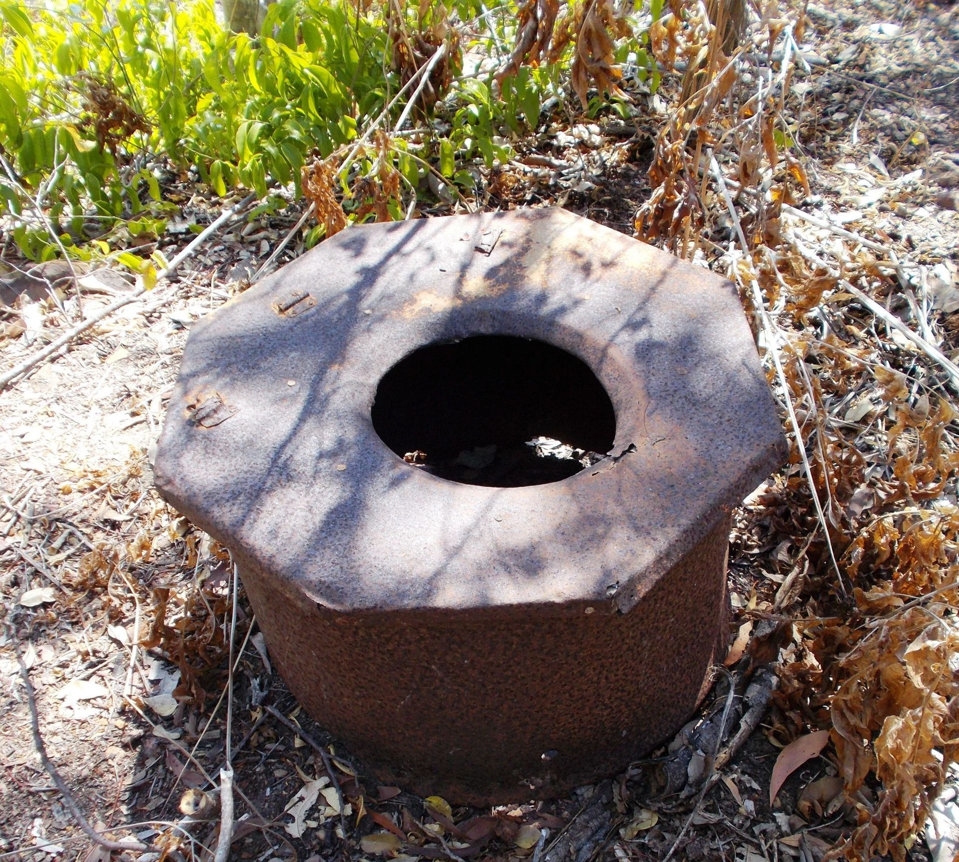 A rusty object with a hole in the middle of it