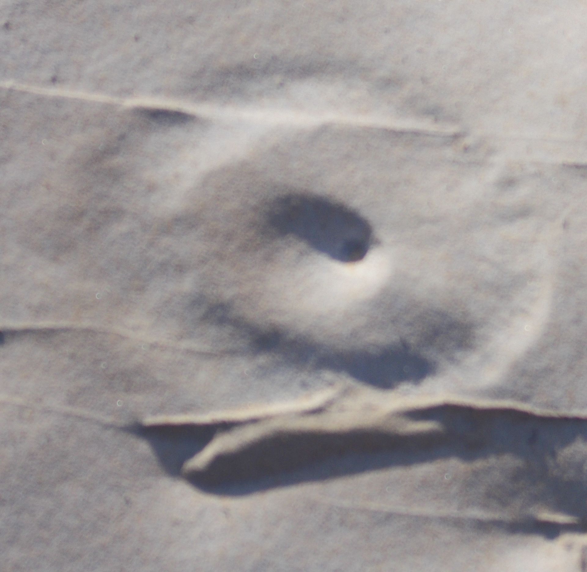 A close up of a piece of paper with a hole in it