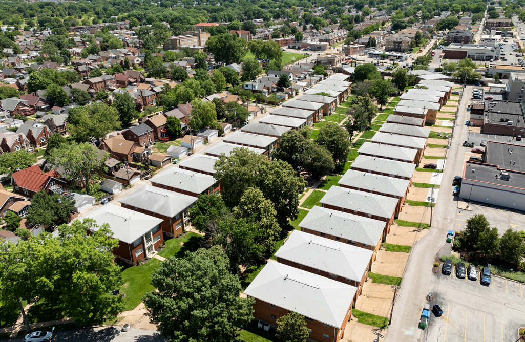 An aerial view of a residential area with lots of houses and trees.
