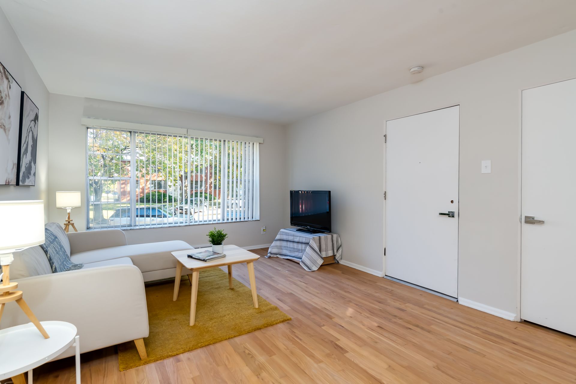 A living room with a couch , table , and television.