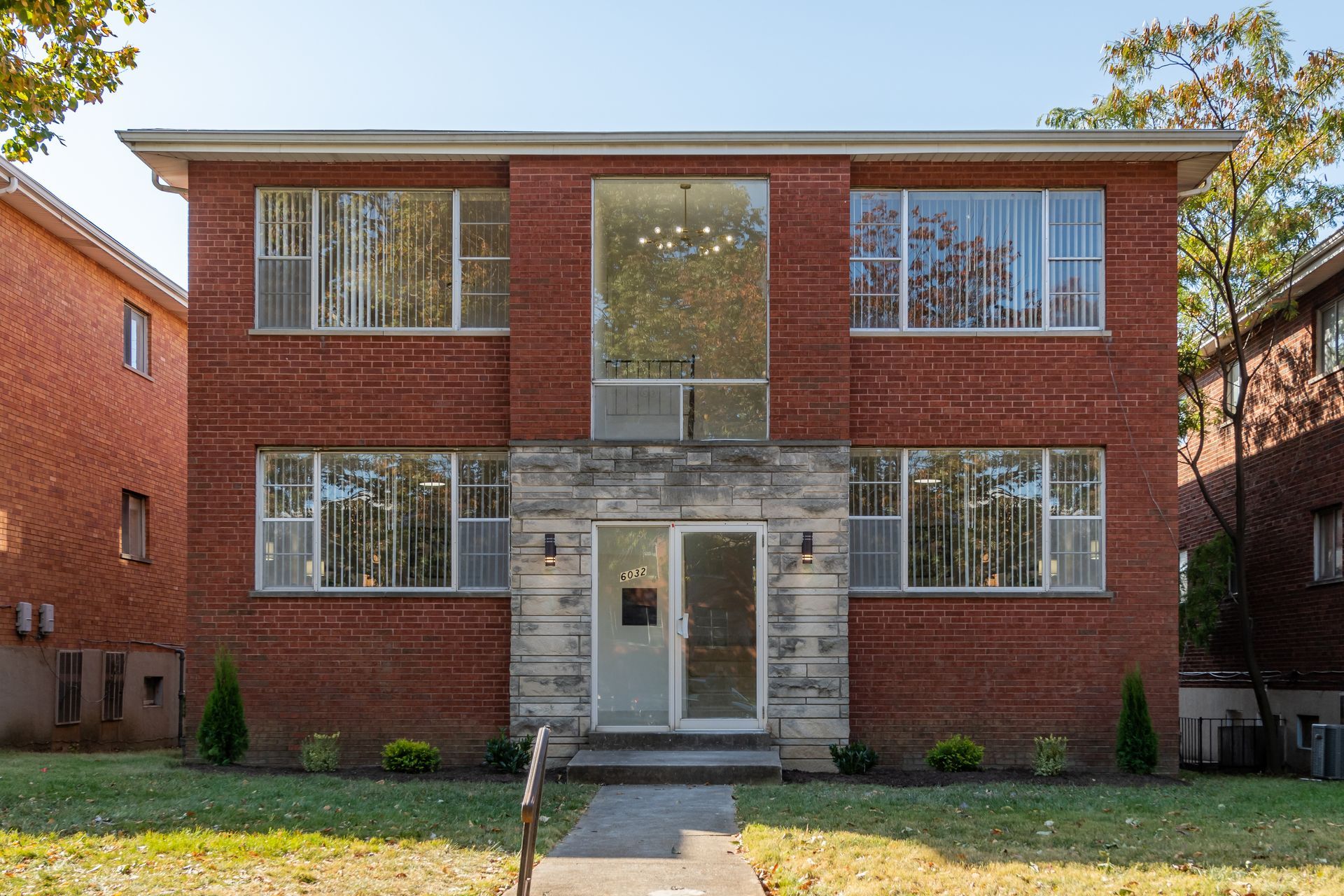A large red brick apartment building with lots of windows