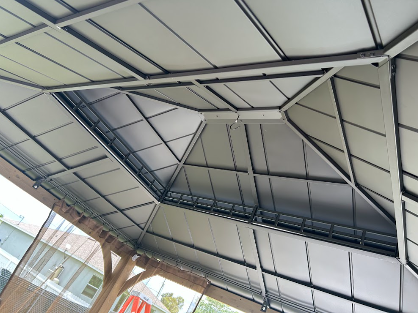 Metal gazebo roof with angled supports.