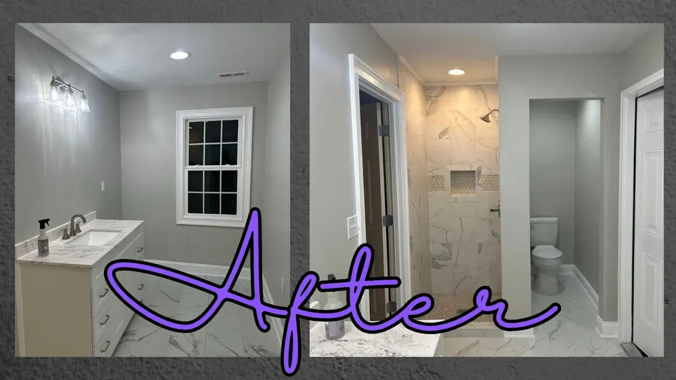 Newly renovated bathroom with grey walls, marble shower, double vanity, and toilet.