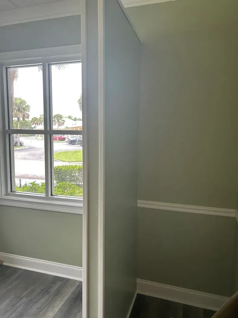A room with a window with a fresh coat of paint
