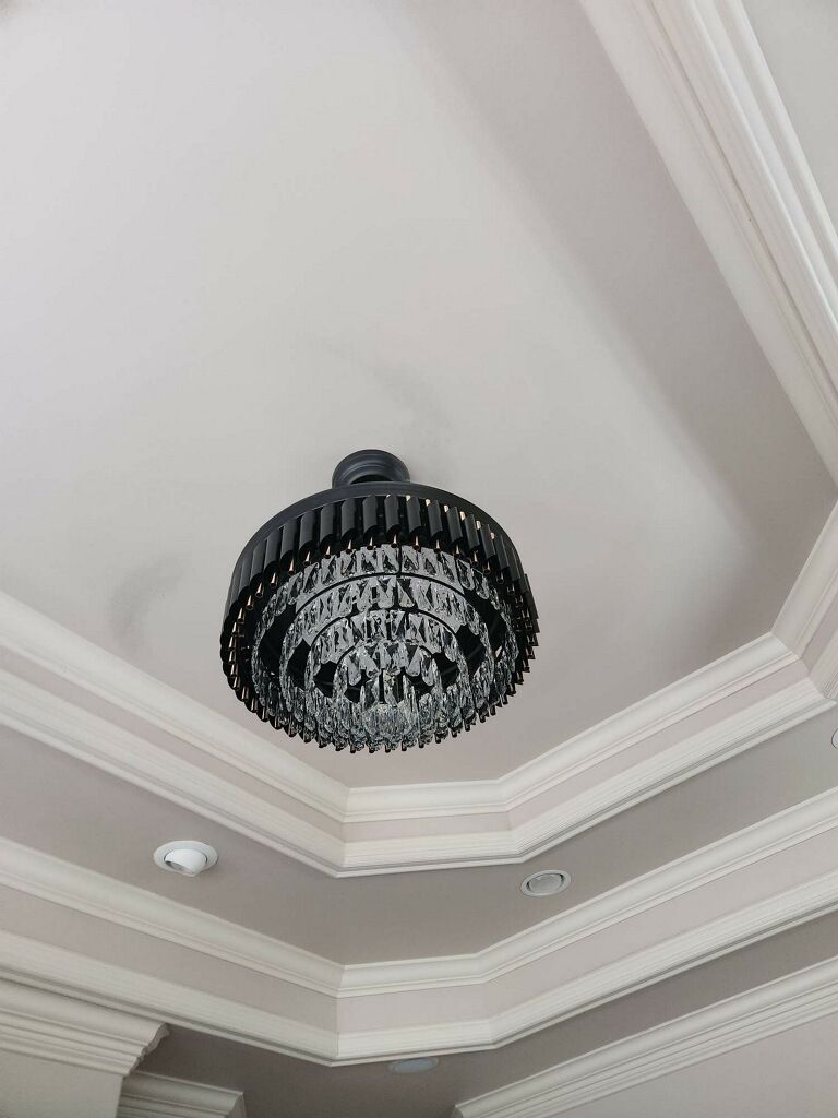 A chandelier is hanging from the ceiling of a room.