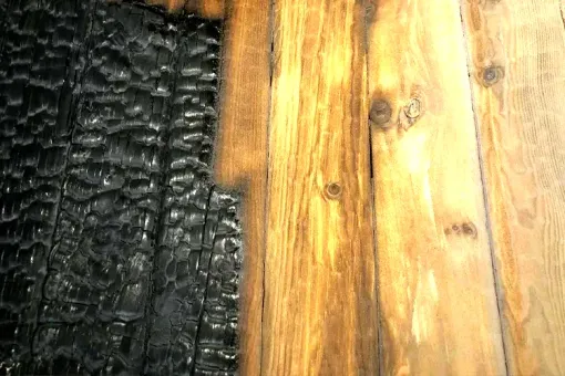 Before and after fire restoration on wood with sandblasting