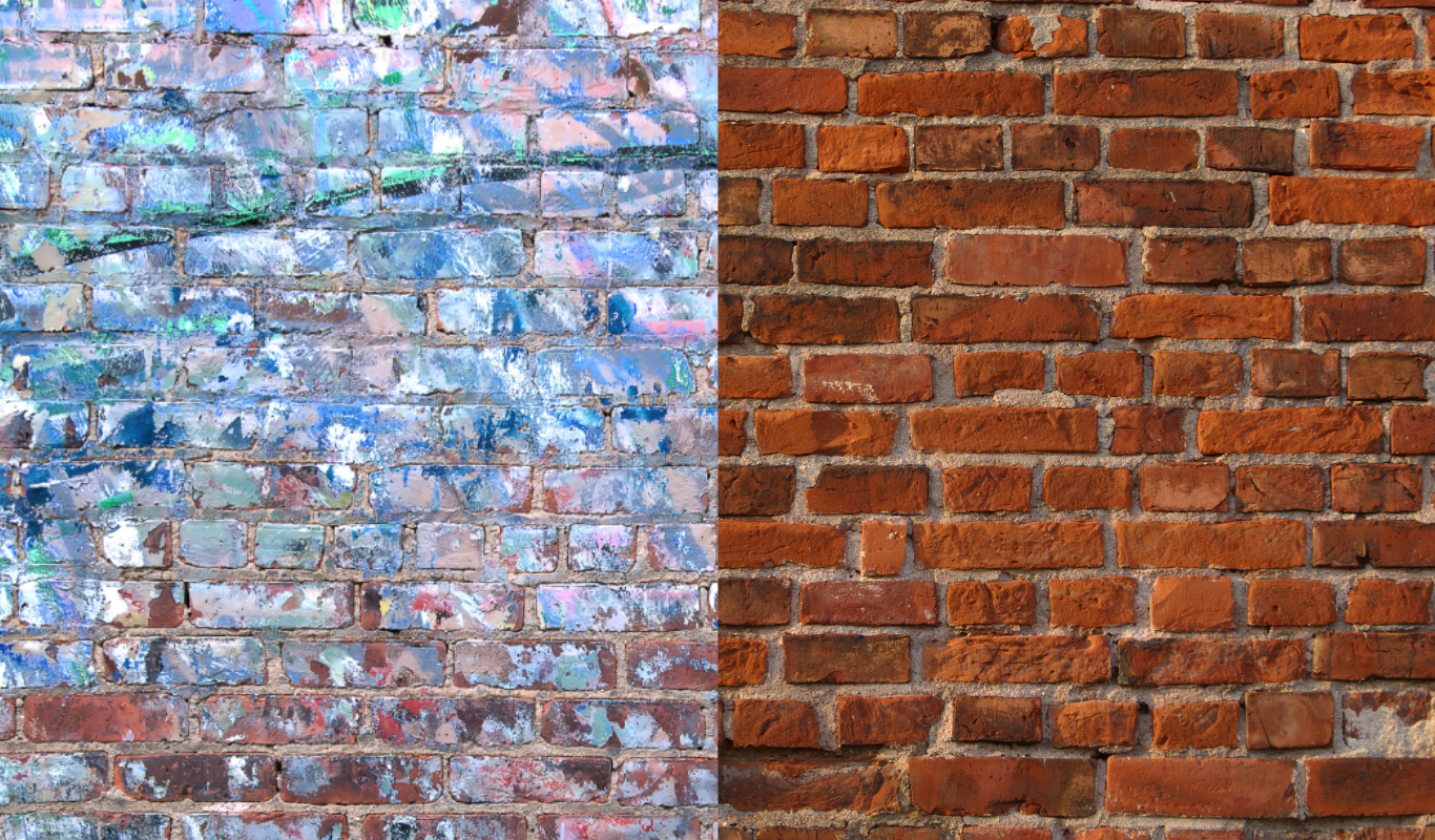 A brick wall with a painting on it and a brick wall without a painting on it.