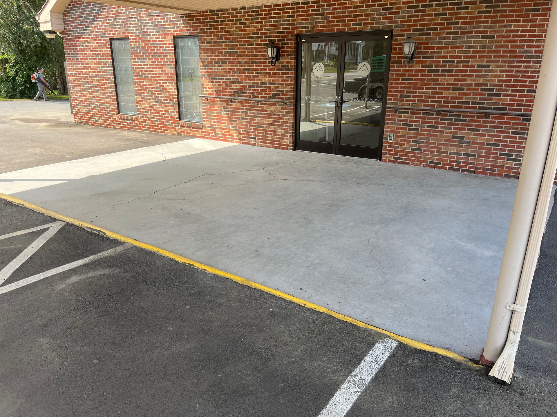 A brick building with a parking lot in front of it
