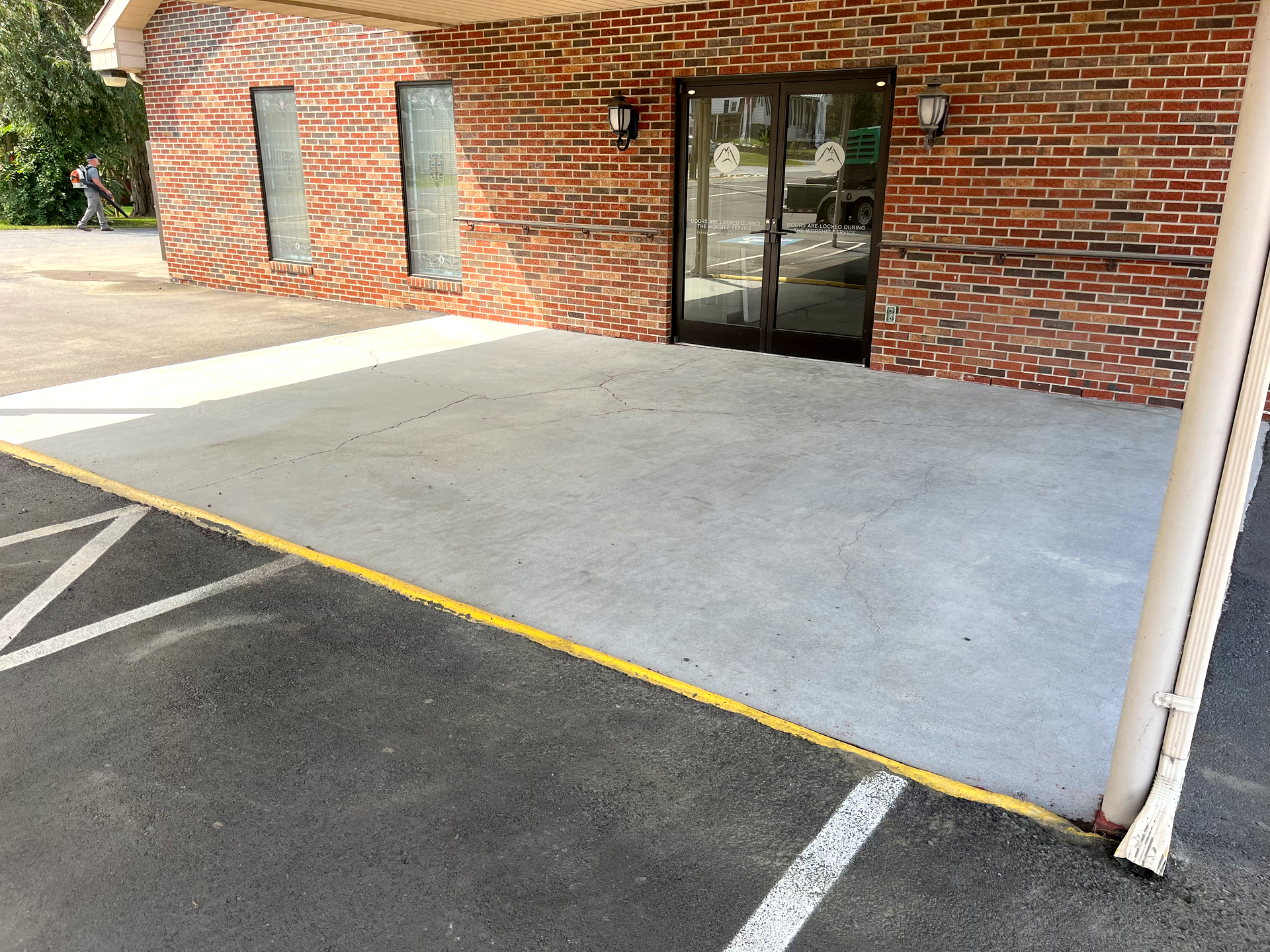 A brick building with a parking lot in front of it