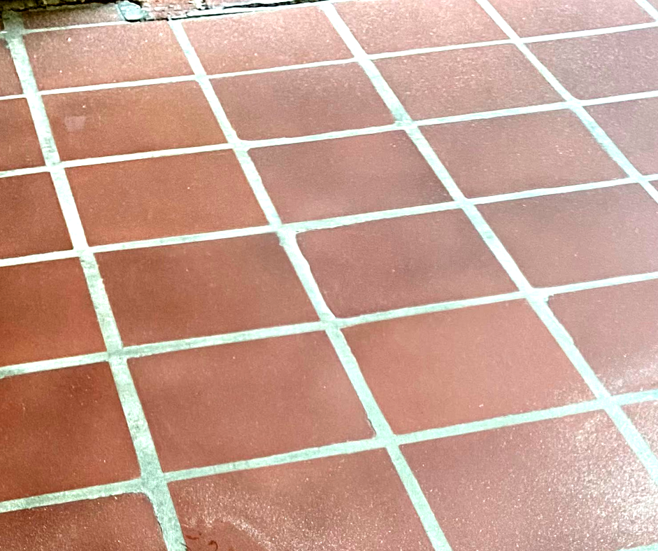 A close up of a tiled floor with white lines