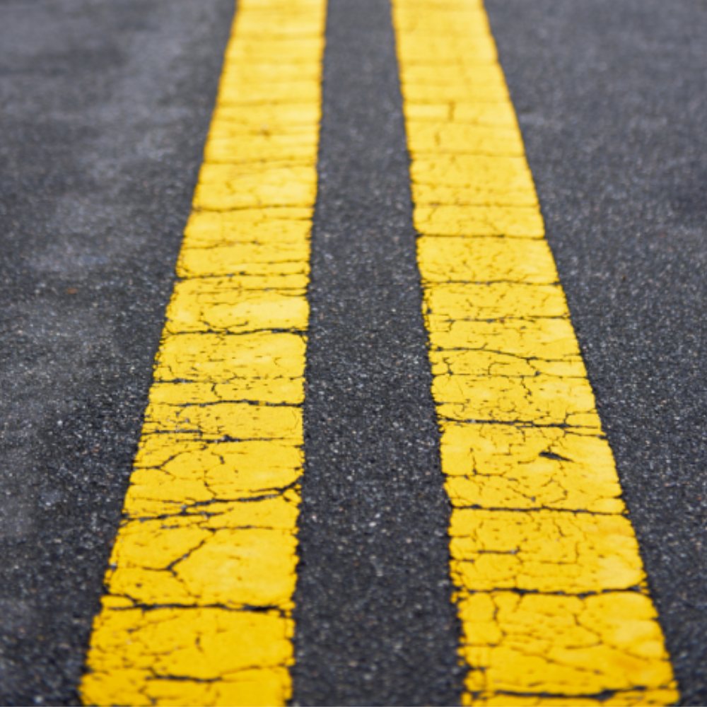 A close up of two yellow lines on a road
