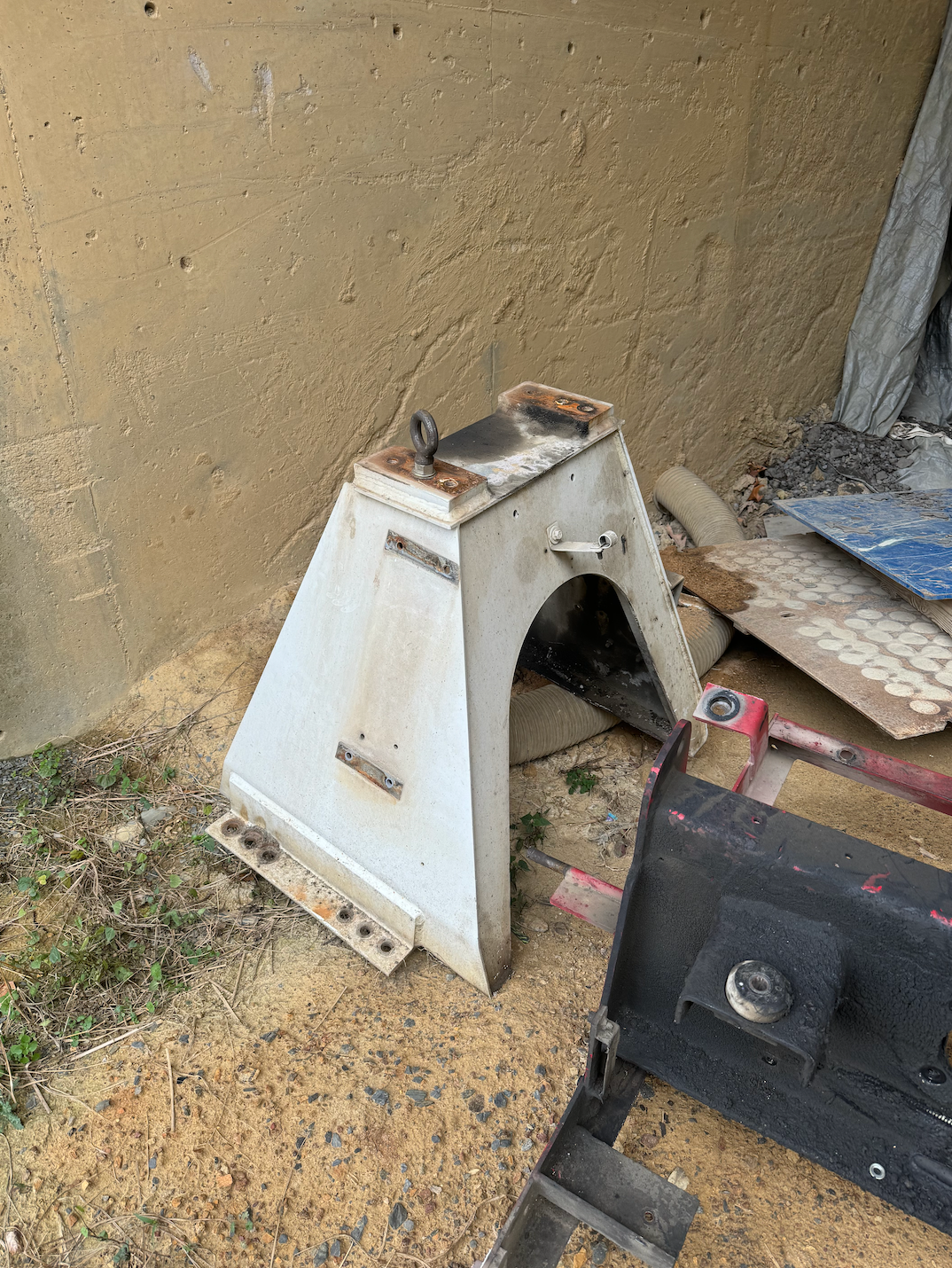 A piece of metal is sitting on top of a pile of wood.