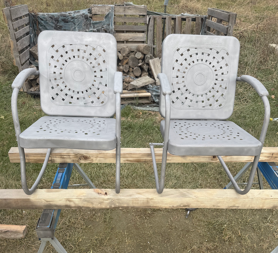 Two chairs are sitting on top of a wooden bench.