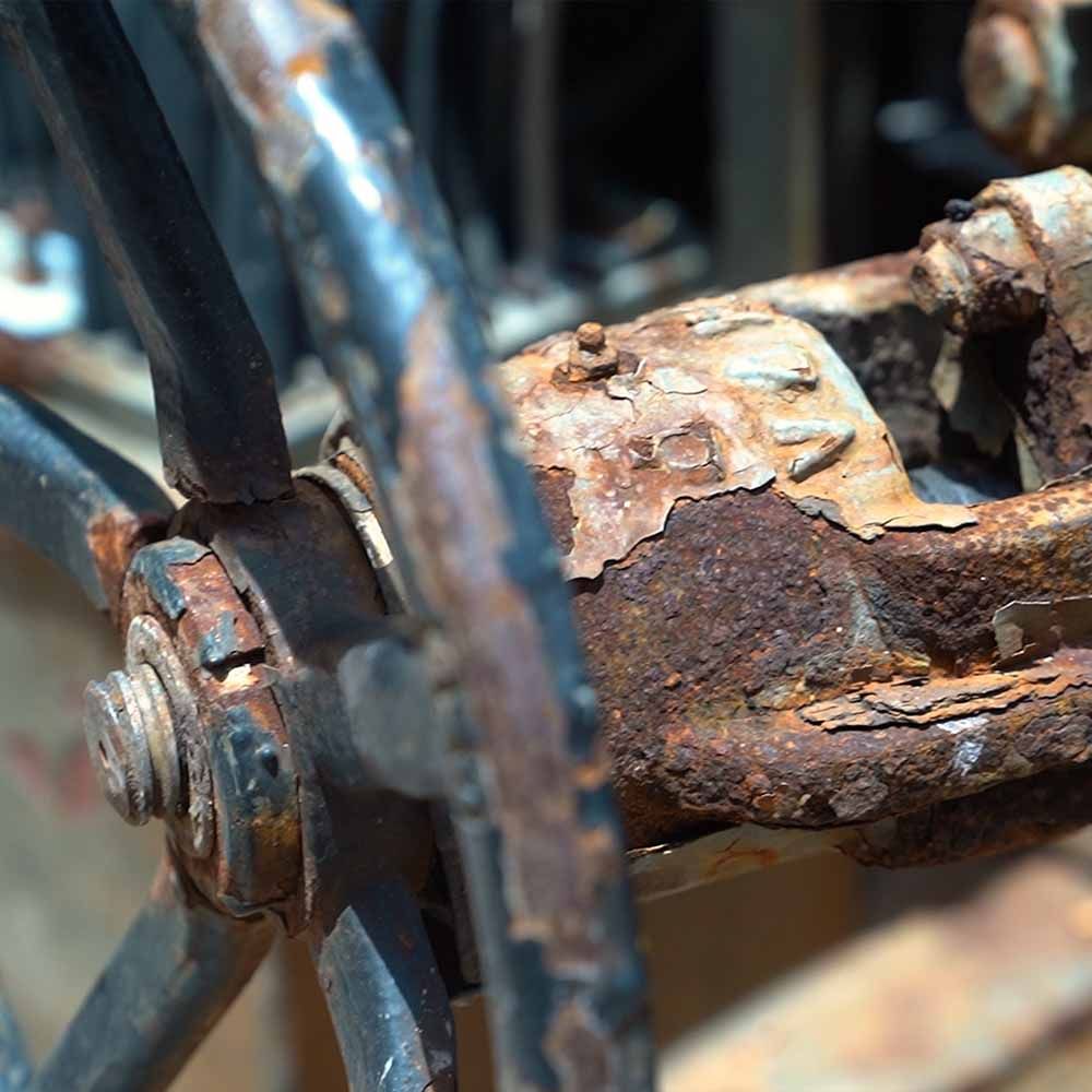 A close up of a rusty wheel on a bicycle