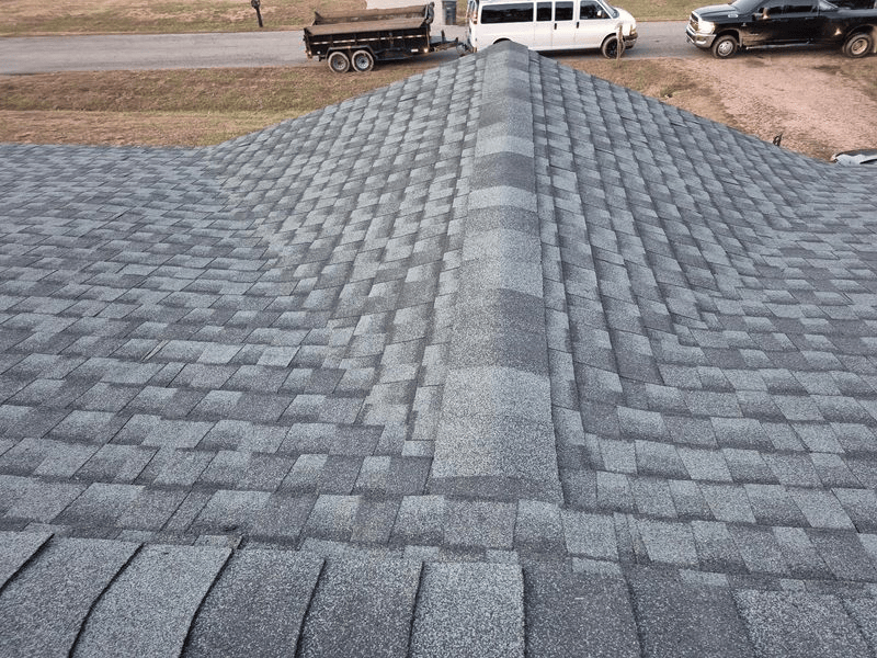 Gray shingle roof with dark ridge cap