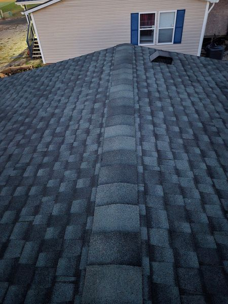 Dark gray shingle roof with a central row of lighter gray shingles