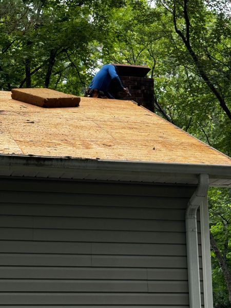 Person on roof near chimney