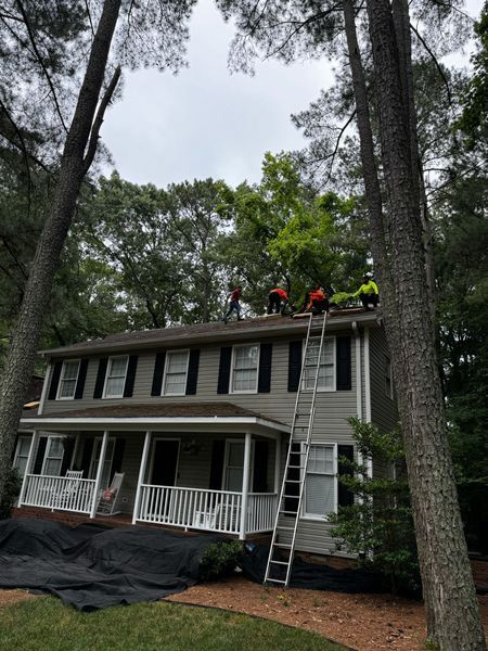Roofing crew on a two-story house roof