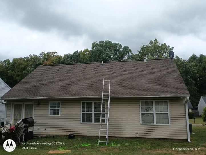 House with brown roof and a ladder