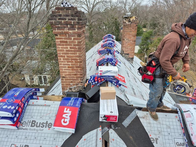 Roofer on a roof installing shingles