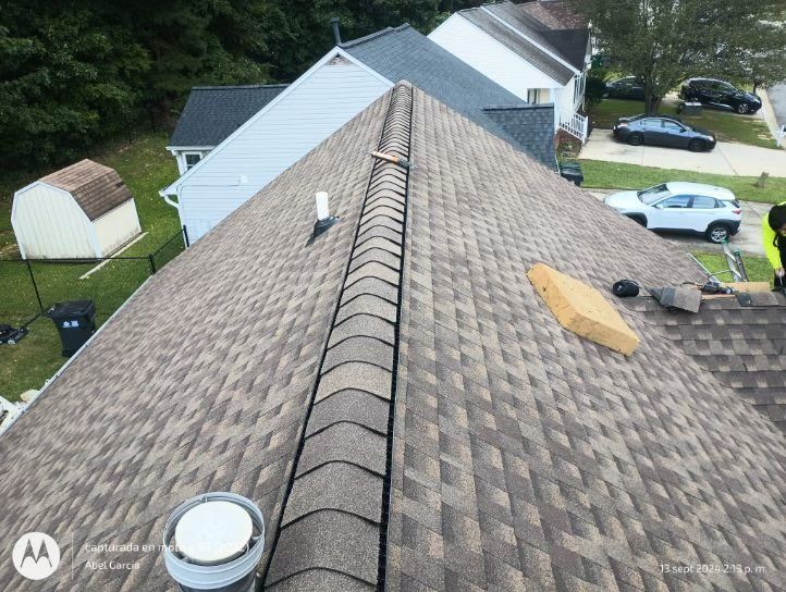 View of a house roof with brown shingles