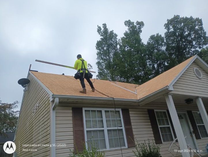 Roofer on a house roof